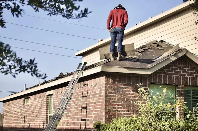 Professional roofer working on a residential roof in Algonquin